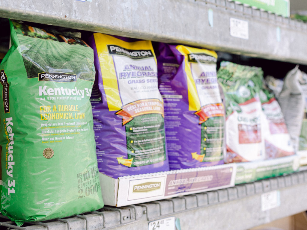 Pennington turfgrass bags on a shelf.
