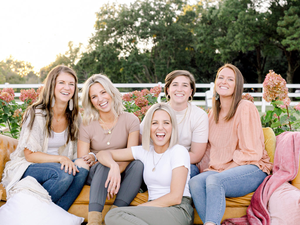 Those Plant Ladies dream team hanging out on a sofa outdoors