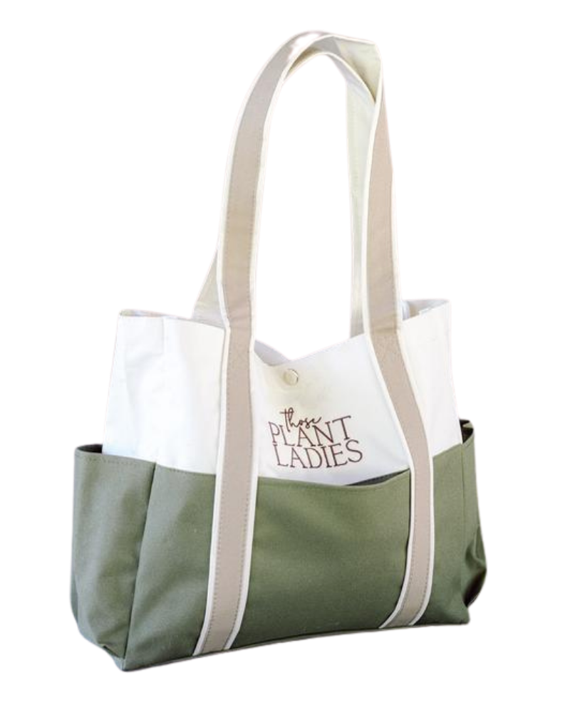 Garden tote from Those Plant Ladies: green around the bottom, ivory on the top, and tan handles with Those Plant Ladies logo. Exterior pocket visible.