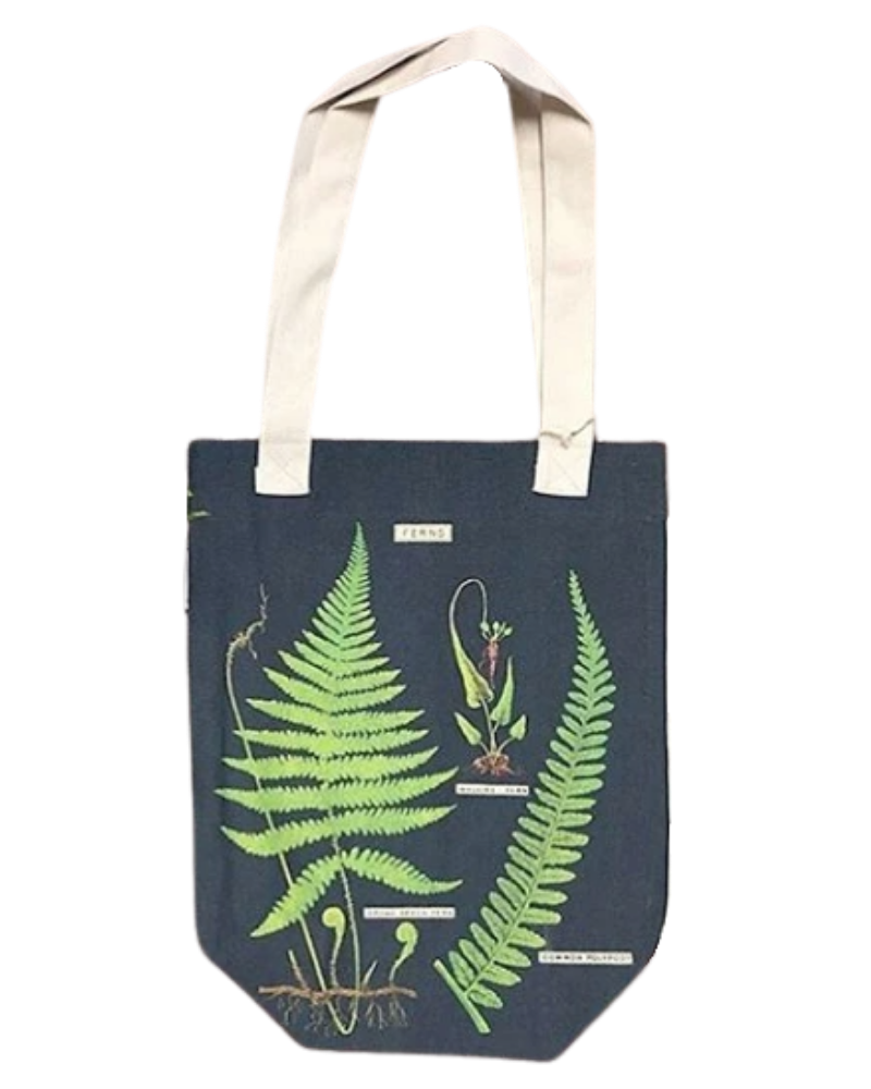 Fern tote bag from Those Plant Ladies. Navy background with green ferns; neutral straps.