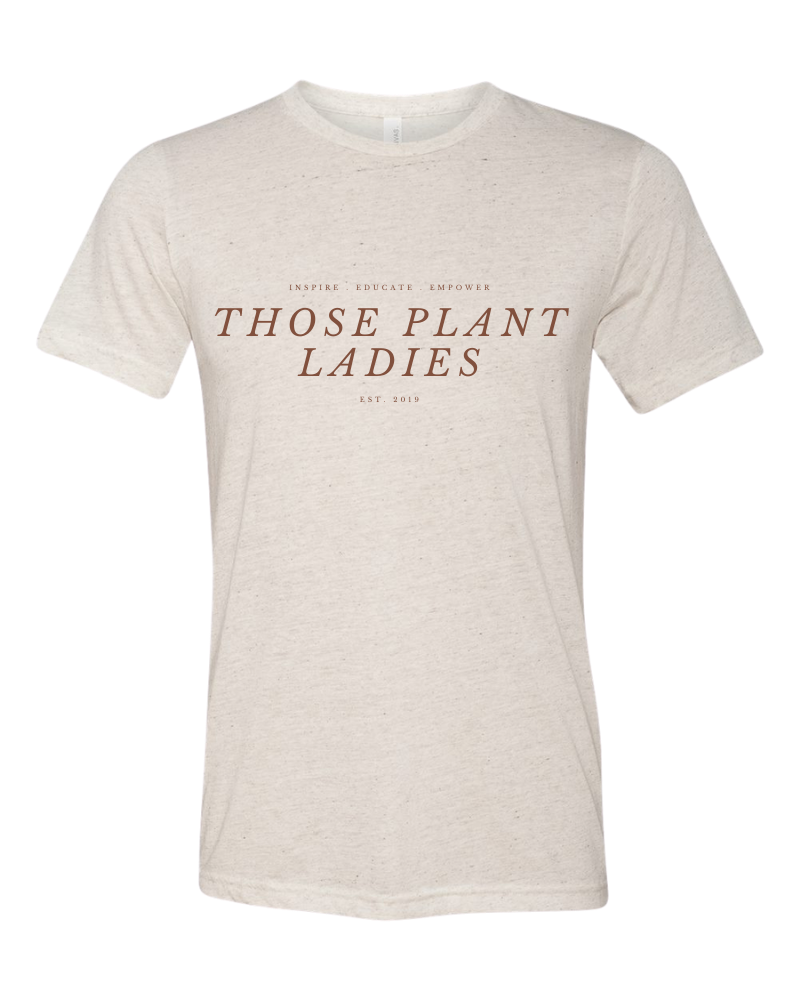 Those Plant Ladies mission tee, short-sleeved. Oatmeal tshirt with cognac lettering: inspire, educate, empower, Those Plant Ladies.