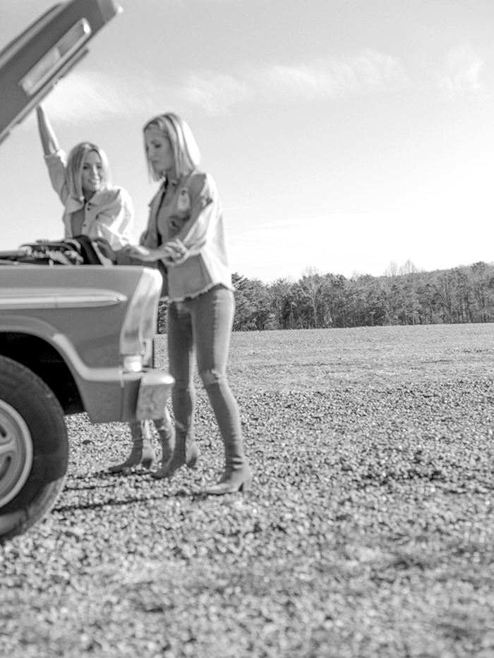 Fawn and Heather from Those Plant Ladies working on a pickup truck.