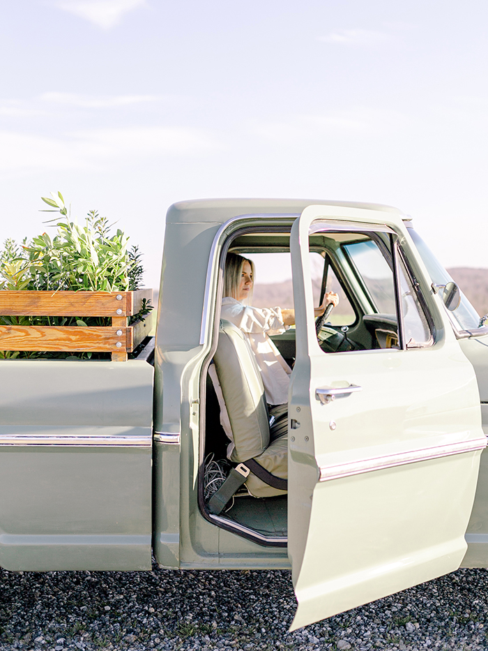Fawn of Those Plant Ladies driving a retro pickup truck.