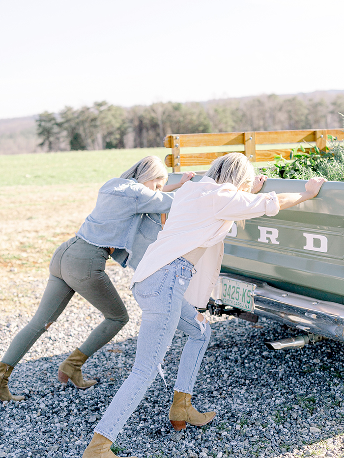 Those Plant Ladies Fawn and Heather pushing a green Ford pickup truck.