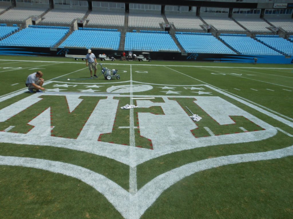 The NFL logo being painted at the Carolina Panthers' stadium.